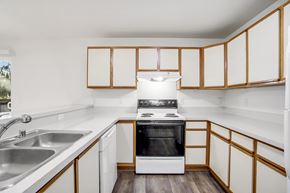 Lacey townhouse for rent - A kitchen with white cabinets and a black oven.