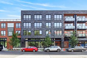 Seattle apartment for rent - A red car is parked in front of a building with the word "ARBOR" on it.