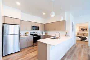 Bend apartment for rent - a kitchen with an island and a stainless steel refrigerator