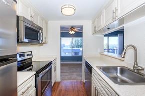 Kirkland apartment for rent - a kitchen with stainless steel appliances and white cabinets