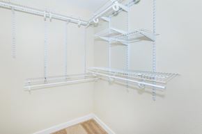 Kirkland apartment for rent - a spacious closet with white shelves and white walls