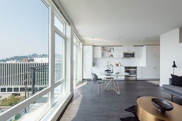 Seattle apartment for rent - a living room with a table and chairs and a balcony