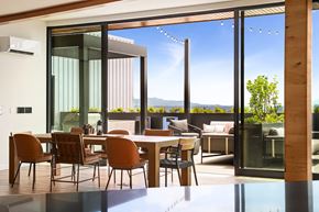 Seattle apartment for rent - A modern dining room with a glass table and chairs.