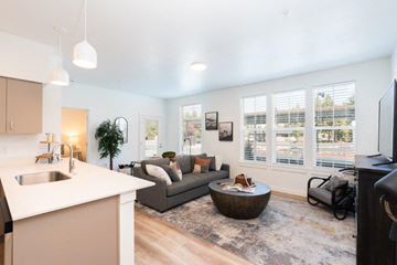 Bend apartment for rent - a living room and kitchen with a couch and a table