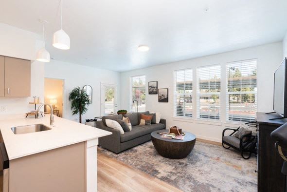 Bend apartment for rent - a living room and kitchen with a couch and a table