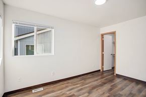 Lacey townhouse for rent - A room with a wooden floor and a window with a view of a building.