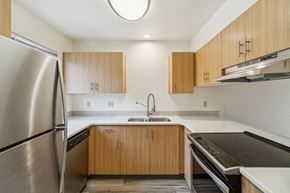 Bend apartment for rent - A modern kitchen with wooden cabinets and stainless steel appliances.