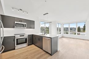Seattle apartment for rent - A modern kitchen with stainless steel appliances and wooden floors.