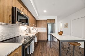 Seattle apartment for rent - a modern kitchen with stainless steel appliances and wooden cabinets