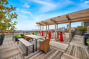 Seattle apartment for rent - the deck on the roof of a building with tables and chairs