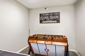 Renton apartment for rent - A game room with a pool table and a sign on the wall.