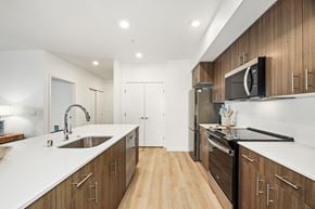 Arlington apartment for rent - A modern kitchen with wooden cabinets and stainless steel appliances.