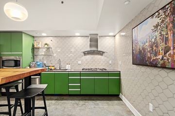 Bellevue apartment for rent - A kitchen with green cabinets and a wooden table.