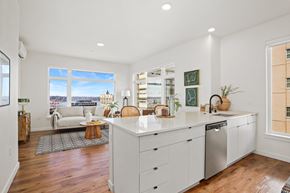 Seattle apartment for rent - A kitchen with white cabinets and a large island.