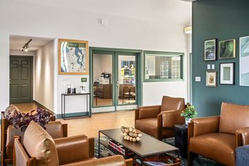 Seattle apartment for rent - A living room with brown leather chairs and a coffee table.