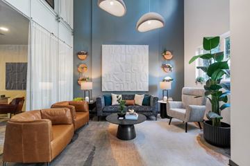 Portland apartment for rent - A living room with a large couch and a coffee table.