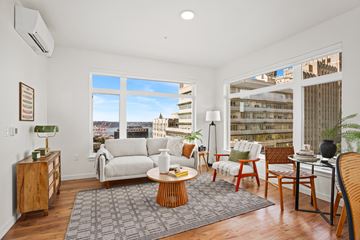 Seattle apartment for rent - A living room with a white couch and a large window.