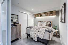 Seattle apartment for rent - a bedroom with a white bed and a grey blanket
