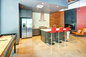 Seattle apartment for rent - a large kitchen with a long island with red chairs and a foosball table