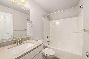 Seatac apartment for rent - A white bathroom with a toilet, sink, and bathtub.