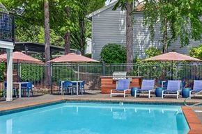 Lynnwood apartment for rent - A pool surrounded by chairs and umbrellas.