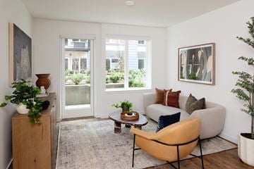 Shoreline apartment for rent - A living room with a yellow chair and a brown table.