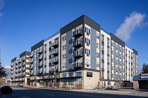 Shoreline apartment for rent - A large, modern apartment building with balconies on the upper floors.