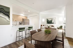 Vancouver townhouse for rent - A modern dining room with a wooden table and chairs.