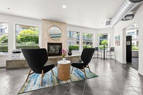 Seattle apartment for rent - a living room with a fireplace and a table with two chairs
