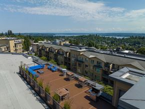 Seattle apartment for rent - A view of a rooftop with a pool and a few chairs.