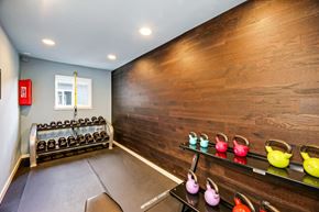 Seattle apartment for rent - the gym has a wall of reclaimed wood and a rack of shoes