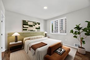Seattle apartment for rent - A bedroom with two beds and a large painting on the wall.