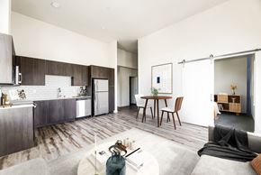 Poulsbo apartment for rent - a kitchen and living room with white walls and hardwood floors