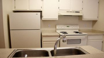 Kent apartment for rent - A kitchen with a white stove and white cabinets.