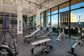 Tacoma apartment for rent - a gym with weights and cardio equipment and windows