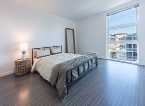 Seattle apartment for rent - a bedroom with a bed and a large window