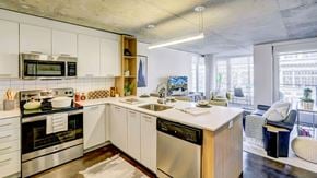 Seattle apartment for rent - A modern kitchen with stainless steel appliances and white cabinetry.
