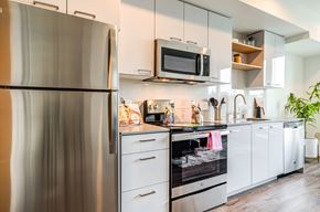 Seattle apartment for rent - a kitchen with stainless steel appliances and white cabinets