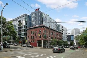 Seattle apartment for rent - A city street with cars and buildings.
