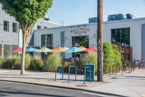 Portland apartment for rent - the exterior of pollywood trader on a sidewalk with umbrellas