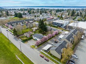 Seattle apartment for rent - A view of a residential area with houses, cars, and a street.