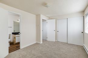 Seattle apartment for rent - A bedroom with a white door and a carpeted floor.