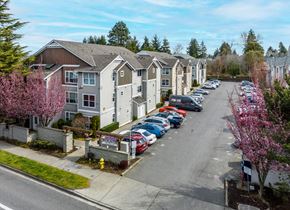 Seattle apartment for rent - A parking lot with cars and apartment buildings in the background.