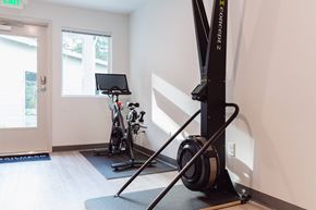 Bremerton apartment for rent - a home gym with exercise equipment in a white room
