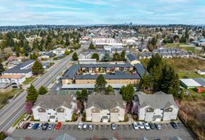 Seattle apartment for rent - A view of a residential area with houses and a parking lot.