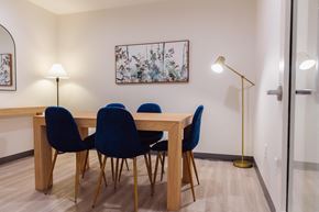 Bremerton apartment for rent - a dining room with a wooden table and blue chairs