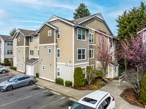 Seattle apartment for rent - A residential building with a parking lot in front.