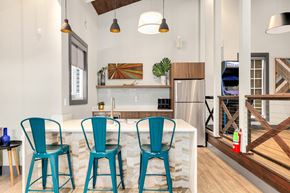 Kent apartment for rent - a kitchen with blue chairs and a marble counter top