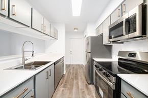 Lacey apartment for rent - a modern kitchen with white counter tops and stainless steel appliances
