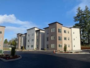 Tacoma apartment for rent - A large building complex with multiple buildings and a parking lot in front.